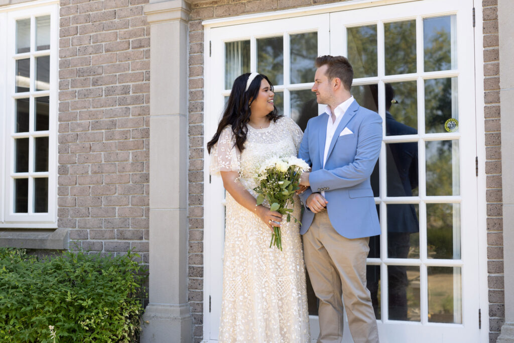 Bride and groom stood outside home