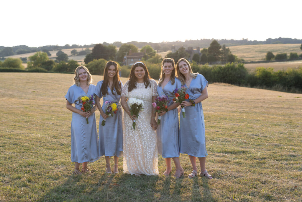 Bride with bridesmaids at sunset