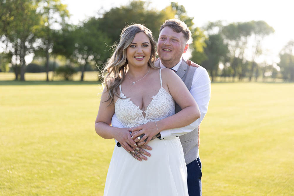 Bride and groom at golden hour on ground of Witney Lakes Resort